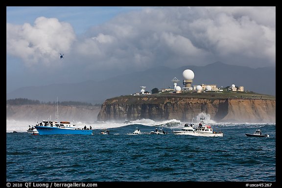 Flottila of boats near Mavericks break in front of Pillar Point radar station. Half Moon Bay, California, USA