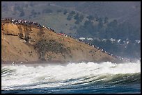 Bluff with spectators as seen from the ocean. Half Moon Bay, California, USA (color)