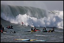 Waverunners and surfer in big wave. Half Moon Bay, California, USA