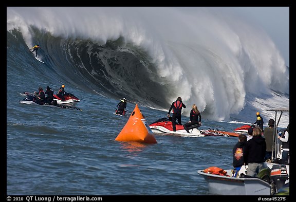 Surfer on big surf and observers. Half Moon Bay, California, USA