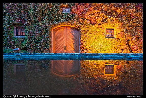 Ivy-covered facade reflected in pool at night. Napa Valley, California, USA (color)