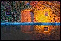 Ivy-covered facade reflected in pool at night. Napa Valley, California, USA ( color)