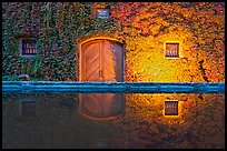 Ivy-covered facade reflected in pool at night. Napa Valley, California, USA