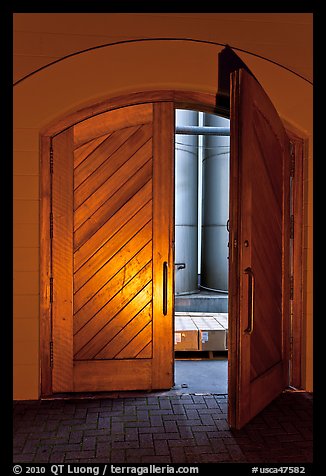 Wooden door opening to wine storage tanks. Napa Valley, California, USA (color)