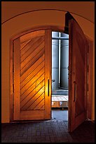 Wooden door opening to wine storage tanks. Napa Valley, California, USA (color)