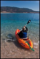 Sea kayaker with fishing rod in Carmel Bay. Carmel-by-the-Sea, California, USA