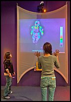 Girls play with thermal imaging camera, Tech Museum. San Jose, California, USA (color)