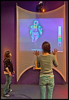 Girls play with thermal imaging camera, Tech Museum. San Jose, California, USA