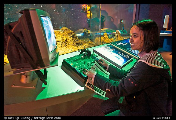 Visitor controls robot, Tech Museum. San Jose, California, USA