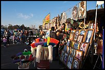 Brooms and religious pictures for sale, San Jose Flee Market. San Jose, California, USA