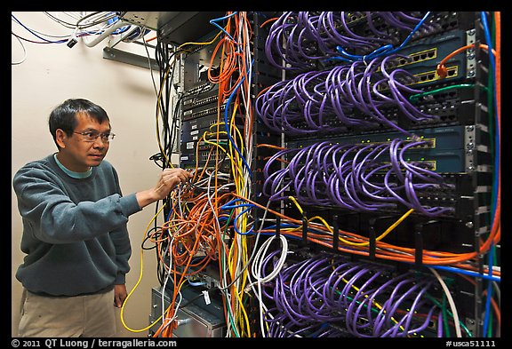 Technician rearranging data cables. Menlo Park,  California, USA