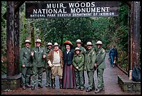 Rangers posing with Theodore Roosevelt under entrance gate. Muir Woods National Monument, California, USA (color)