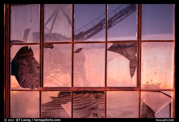 Crane reflected in broken windows, Rosie the Riveter Home Front National Historical Park. Richmond, California, USA