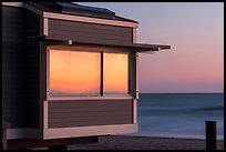 Sunset reflected in beach house window, Stinson Beach. California, USA (color)