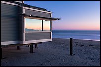 Modern beach house with large window reflecting sunset, Stinson Beach. California, USA (color)