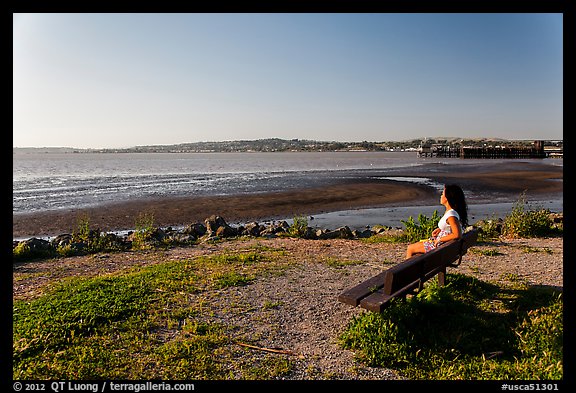 Woman sitting on bench, Carquinez Strait Regional Shoreline. Martinez, California, USA (color)