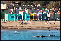 Surfers, beach, and Venetian hotel cottages. Capitola, California, USA