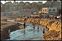 Children playing in tidal stream. Capitola, California, USA