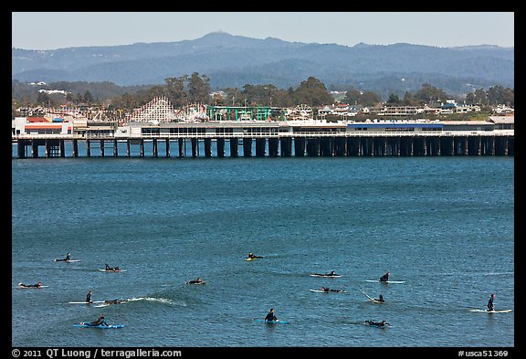 Surfers and municipal wharf. Santa Cruz, California, USA