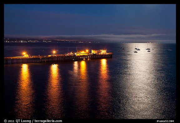 Pier and yachts with moon reflection. Capitola, California, USA