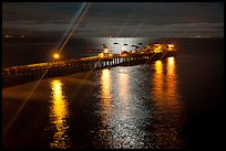 Wharf with moon reflections and light rays. Capitola, California, USA