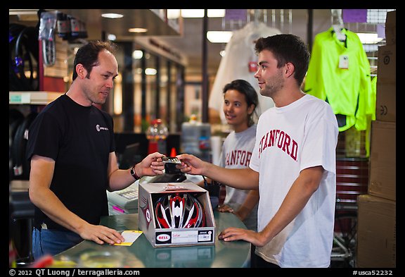 Students paying at register with credit card, Campus Bike Shop. Stanford University, California, USA