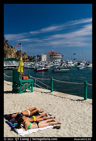 Women sunning on beach near harbor, Avalon, Catalina. California, USA (color)