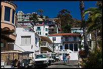 Street with hillside houses looming above, Avalon, Catalina. California, USA (color)