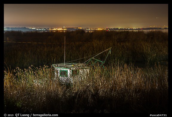 Fishing boat amongst tall grasses by night, Alviso. San Jose, California, USA