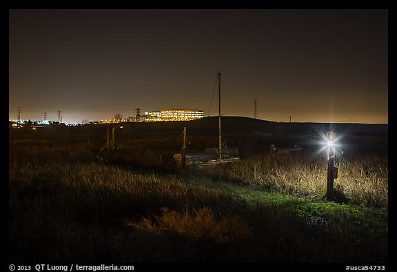 Marsh by night with office building in distance, Alviso. San Jose, California, USA