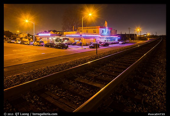 Railroad tracks and restaurant at night, Alviso. San Jose, California, USA (color)