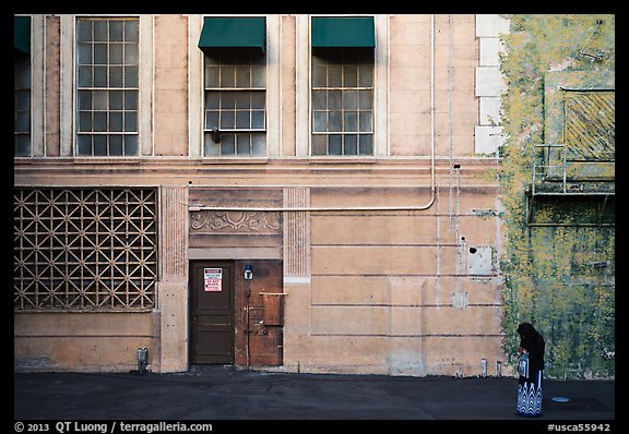 Woman standing in front of false facade, New York backlot, Paramount studios. Hollywood, Los Angeles, California, USA (color)