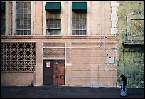 Woman standing in front of false facade, New York backlot, Paramount studios. Hollywood, Los Angeles, California, USA (color)