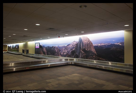 Baggage claim area with Yosemite murals, Fresno Yosemite Airport. California, USA (color)