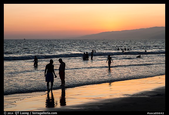 Sunset with beachgoers in water. Santa Monica, Los Angeles, California, USA (color)