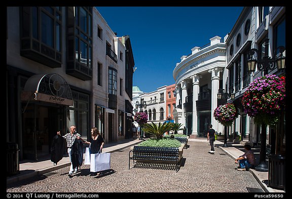 People carry garnments in  Rodeo Drive shopping district. Beverly Hills, Los Angeles, California, USA (color)