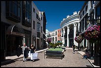 People carry garnments in  Rodeo Drive shopping district. Beverly Hills, Los Angeles, California, USA ( color)