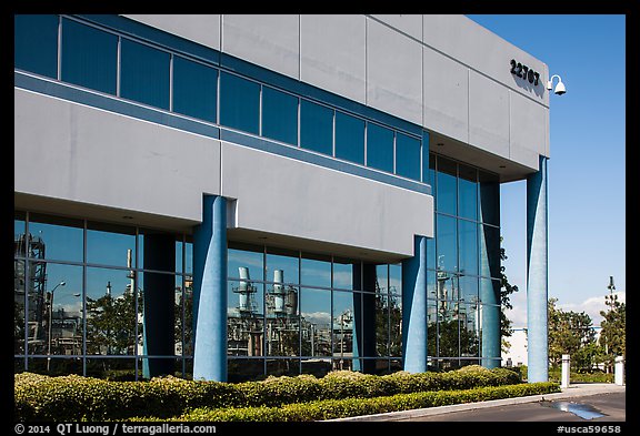 Oil refinery reflected in windows of office building, Manhattan Beach. Los Angeles, California, USA (color)