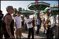 Tourists photograph Ocean Front Walk entertainer. Venice, Los Angeles, California, USA ( color)