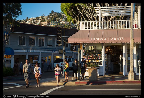 Visitors cross street in shopping area. Laguna Beach, Orange County, California, USA (color)