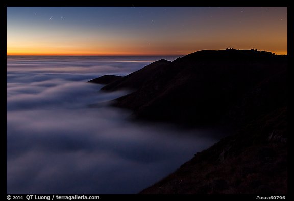 Hills emerging from sea of clouds at dusk, Garrapata State Park. Big Sur, California, USA (color)