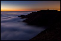 Hills emerging from sea of clouds at dusk, Garrapata State Park. Big Sur, California, USA ( color)