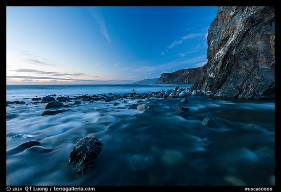 Creek, boulders, cliff, and ocean at dusk. Big Sur, California, USA (color)