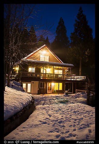 Cabin with window lights in winter. California, USA (color)