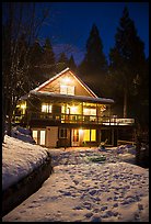 Cabin with window lights in winter. California, USA ( color)