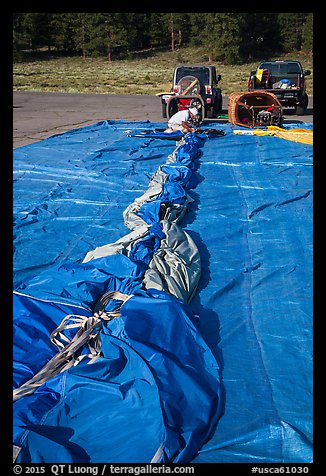 Hot air balloon being folded for transportation, Tahoe National Forest. California, USA (color)