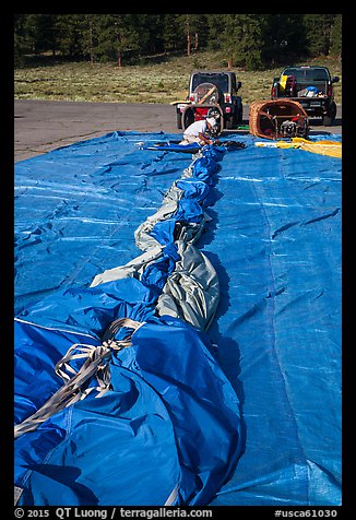 Hot air balloon being folded for transportation, Tahoe National Forest. California, USA (color)