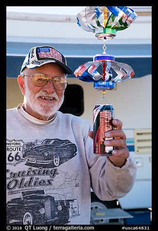 Man with mobile he made out of cans, Slab City. Nyland, California, USA (color)