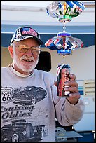 Man with mobile he made out of cans, Slab City. Nyland, California, USA ( color)