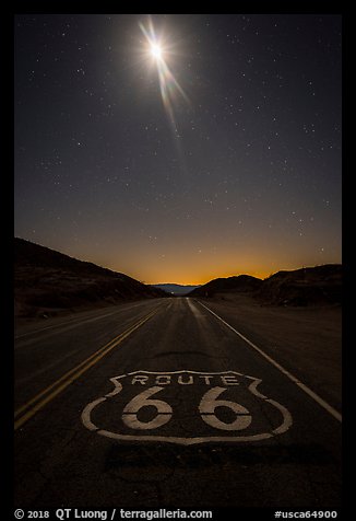 Route 66 marking and moon at night. Mojave Trails National Monument, California, USA